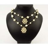 CHANEL NECKLACE, faux pearl and gold tone, with flower head pendants, linking together forming a two