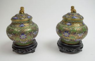 CLOISONNE LIDDED VASES, a pair, 20th century, in green, blue and pinik enamels, the lids adorned