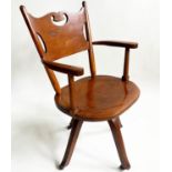 OFFICE CHAIR, 1920's Art Nouveau influenced, carved oak with pierced back, shaped seat revolving