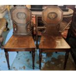 HALL CHAIRS, a pair, each 44cm W x 90cm H, Regency mahogany, circa 1810, with painted Heraldic