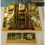 FAUX GOLD BULLION BARS, set of eight, each bar 4cm x 23.5cm x 8cm. (8)