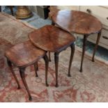 NEST OF THREE TABLES, largest 53cm x 41cm, 20th century walnut, the shaped oval tops on slender