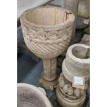 GARDEN URNS, a pair, composite stone, 79cm H x 35cm diam at largest, on differing bases. (2)