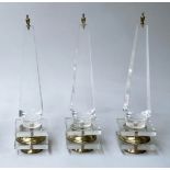 TABLE OBELISKS, a set of three, 42cm H, Lucite, of tapering form on gilded bases. (3)