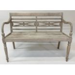 COLONIAL STYLE BENCH, weathered teak with downswept arms and carved pierced back, 115cm W.