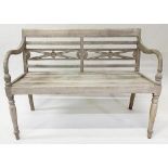 COLONIAL STYLE BENCH, weathered teak with down swept arms and carved pierced back, 115cm W.