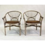 ARMCHAIRS, a pair, rattan framed and cane bound with leather pads, 65cm W. (2)