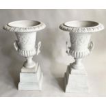 GARDEN URNS, a pair, cast iron campana form on stands, 85cm H x 47cm. (2)