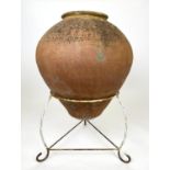 TERRACOTTA OLIVE JAR, of substantial size, early 20th century on wrought iron stand, 94cm H.
