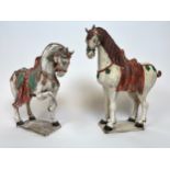 TANG STYLE HORSES, two, painted terracotta, largest 54cm H. (2)