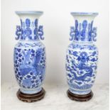 CHINESE BLUE AND WHITE VASES, a pair, on carved wooden stands, 60cm H. (2)