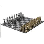 CHESS SET, with gilt and polished metal finish oversized pieces, 60cm x 60cm.