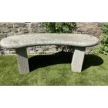 GARDEN BENCH, weathered reconstituted stone of curved form with end supports, 120cm W x 36cm D x