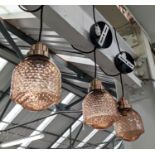 CEILING PENDANT LIGHTS, a set of three amber glass shades, 124cm drop approx. (3)