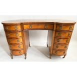 SATINWOOD DESK, Edwardian, kidney shaped with eleven drawers and quarter veneered writing surface,