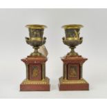 PEDESTAL MANTLE URNS, a pair, possibly French, the urns of two handled form with gilt bronze with