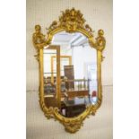 WALL MIRROR, mid 19th century Continental giltwood and gesso with bevelled plate, palmette crest and