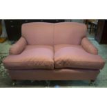 HOWARD STYLE SOFA, 80cm H x 142cm W x 104cm D, dusty rose patterned fabric on brass castors.