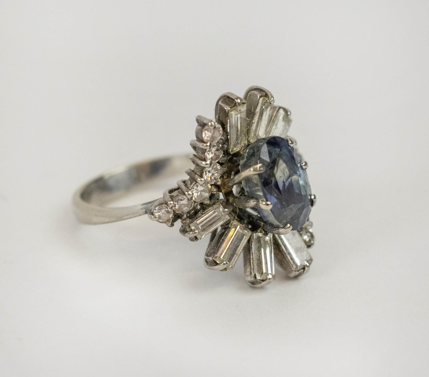 DRESS RING, 18ct white gold diamond and blue stone, the single oval cut blue stone possibly a