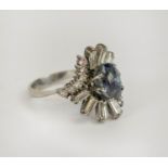 DRESS RING, 18ct white gold diamond and blue stone, the single oval cut blue stone possibly a