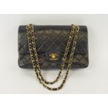 CHANEL FLAP BAG, with front double flap closure, quilted effect and gold hardware, chain and leather