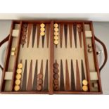 BACKGAMMON SET, in leather case, 7cm x 23cm x 40cm.