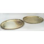 SERVING TRAYS, a pair, white metal, stamped KMS silver, embossed rococo scrolled borders, 61cm L,