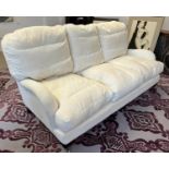 HOWARD STYLE SOFA, three seater, feather filled with turned front supports and castors, 198cm W.