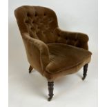 VICTORIAN ARMCHAIR, dark olive velvet button back upholstered with turned front legs and castors,