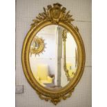 WALL MIRROR, circa 1880, French giltwood and gesso with old oval bevelled plate and cartouche