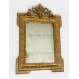 WALL MIRROR, 19th century Italian giltwood and gilt gesso with shield and griffin supports and