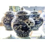 JARS WITH COVERS, a set of three Chinese export style blue and white ceramic, carp decoration,