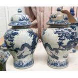BALUSTER VASES WITH COVERS, a pair, Chinese export style blue and white ceramic, dragon