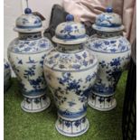 BALUSTER VASES WITH COVERS, a set of three, Chinese export style blue and white ceramic, blossom