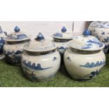 JARS WITH COVERS, a set of four Chinese export style blue and white ceramic scenic decoration,