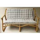 BAMBOO SOFA, framed and cane bound with canvas and striped cushions, 124cm W.