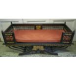 HOWDAH STYLE SOFA, 75cm H x 170cm W x 66cm D, ebonised and gilt heightened, with red squab cushion.