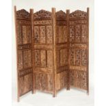 SCREEN, four folds each 52cm W x 182cm H, North Indian carved teak, intricately pierced.