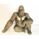 CONTEMPORARY SCHOOL LOUNGING GORILLA SCULPTURE, 52cm x 60cm x 33cm, gilt finish.