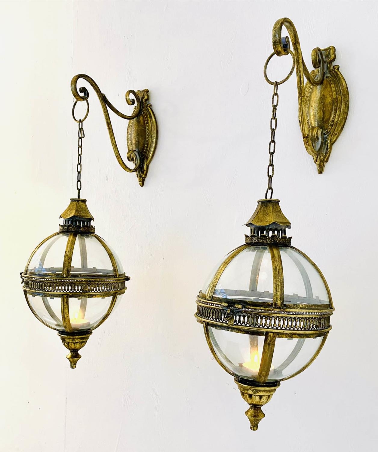 CANDLE LANTERNS, a pair, in the Regency style, 70cm hanging height, of globular form, gilt metal