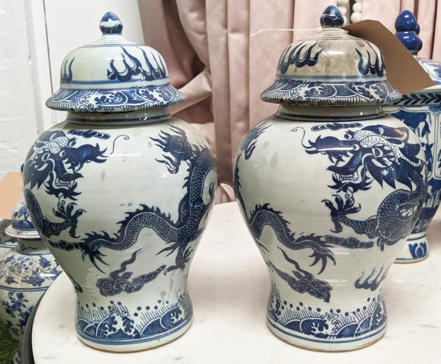 BALUSTER VASES WITH COVERS, a sdet of three, Chinese export style blue and white ceramic, dragon