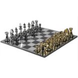 CHESS SET, 60cm sq., with oversized pieces in gilt and silvered finish.