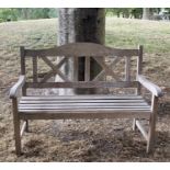 GARDEN BENCH, silvery weathered teak with double 'X' back, 119cm W.