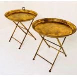 TRAY TABLES, a pair, 66cm x 66cm diam., aged gilt metal. (2)