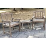 GARDEN ARMCHAIRS AND TABLE, a pair well weathered teak, slatted with arched backs together with a