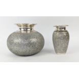 ISLAMIC WHITE METAL VASES, two, one of ovoid form, the other tapered, each with waisted necks,