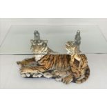 LOW TABLE, 115cm x 70cm x 45cm H, bevelled glass top on a moulded resin tiger and cub support.