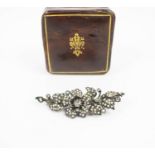 A VICTORIAN WHITE METAL SEED PEARL AND DIAMOND SET FLOWER BROOCH, with a central hand cut diamond of