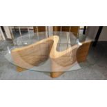 TOM SCHNEIDER SERPENT TABLE, 125cm L x 80cm D x 38cm H, the oval glass top on curved wooden base.