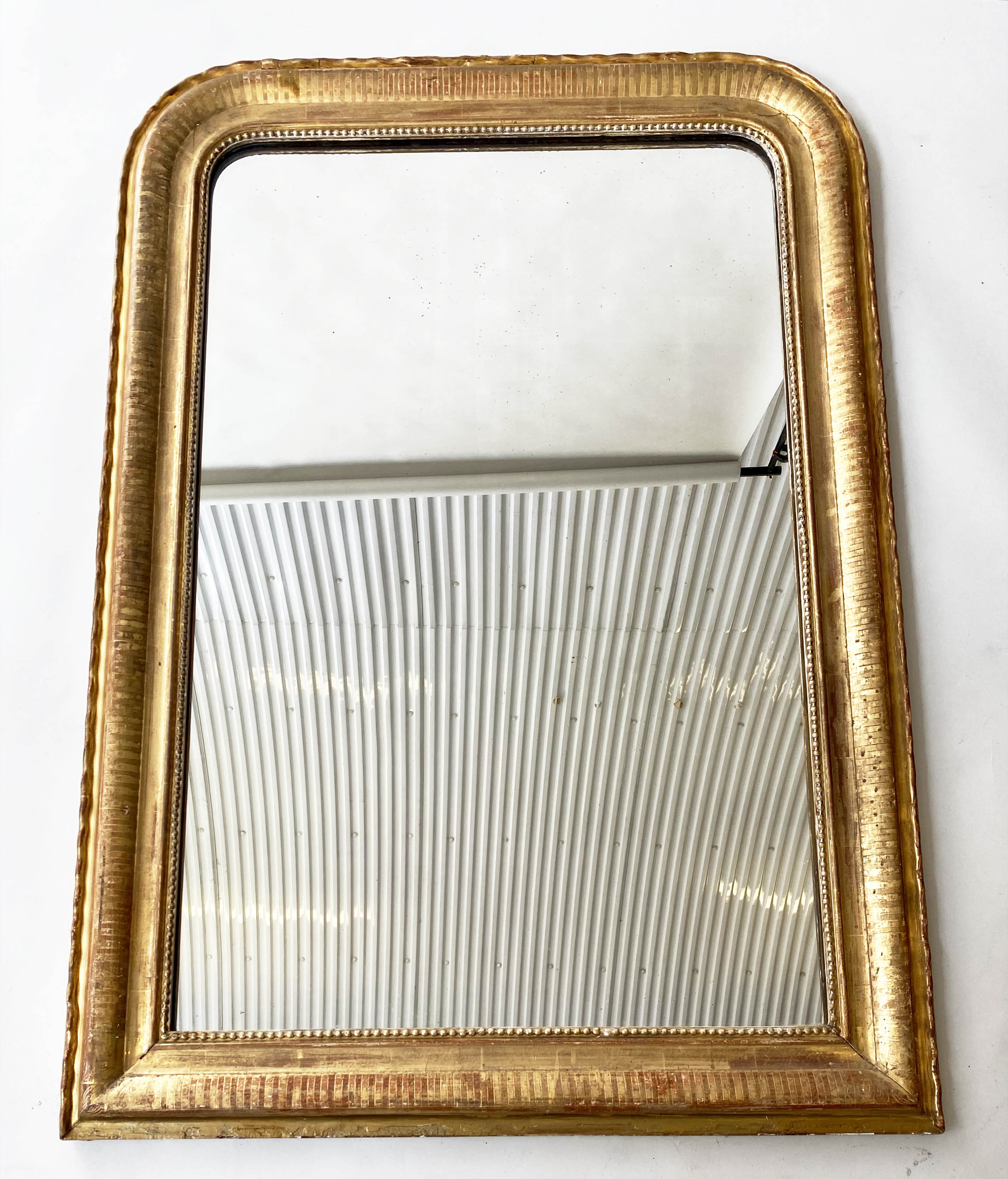 OVERMANTEL MIRROR, 19th century French giltwood with arched beaded frame, 78cm x 112cm H.